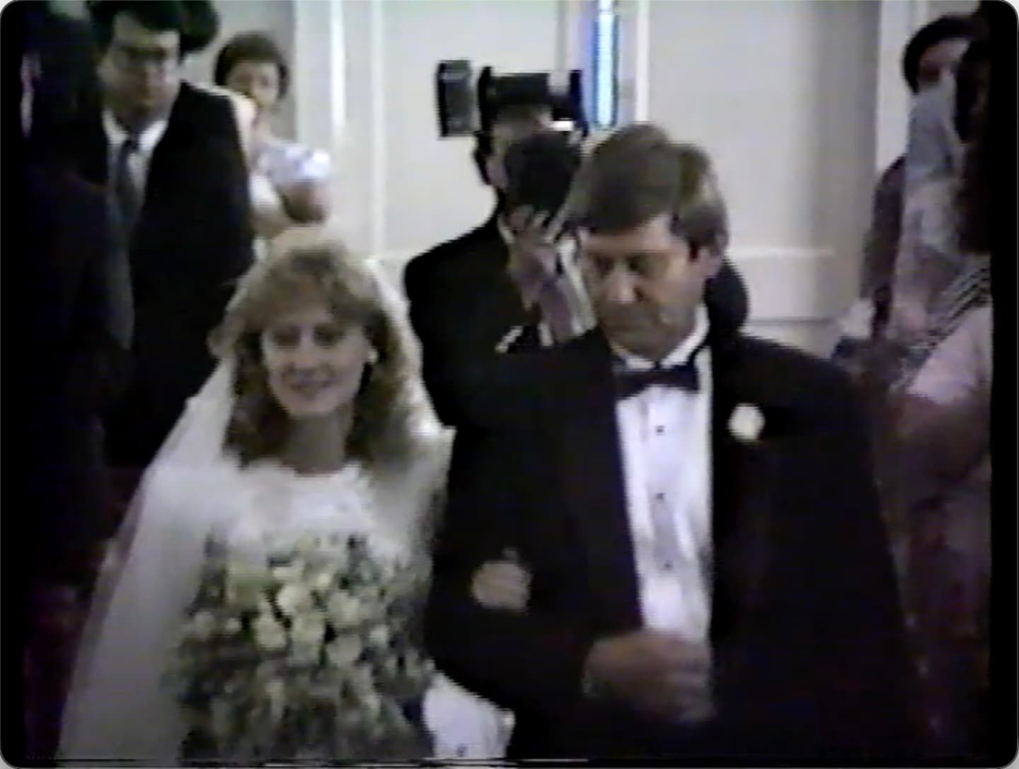 A wedding memory shown as a quiet hover-play video tile